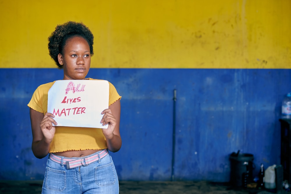 a young boy holding a sign