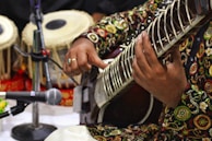 a man playing a musical instrument in front of a microphone