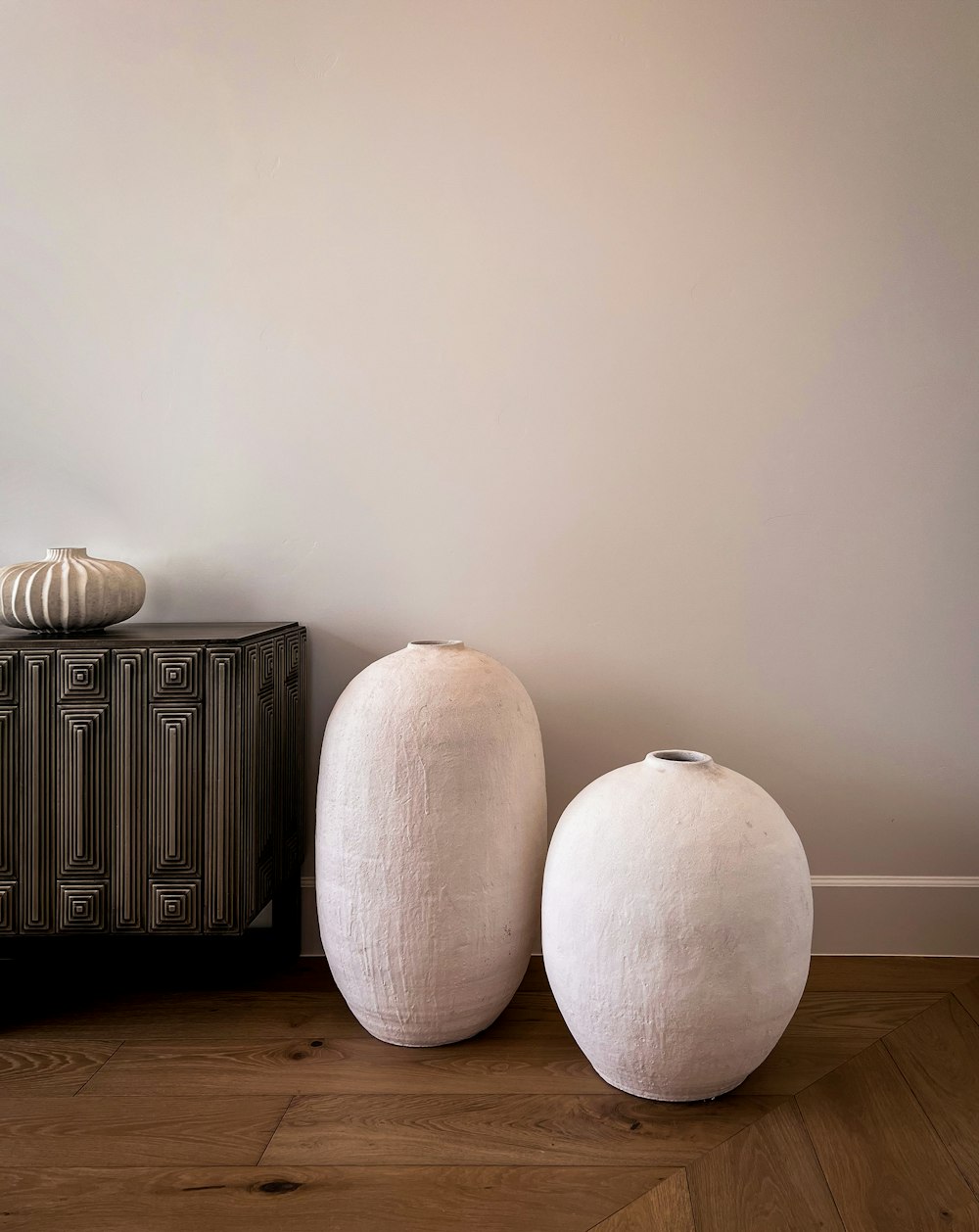 a couple of white balls sitting on top of a wooden floor