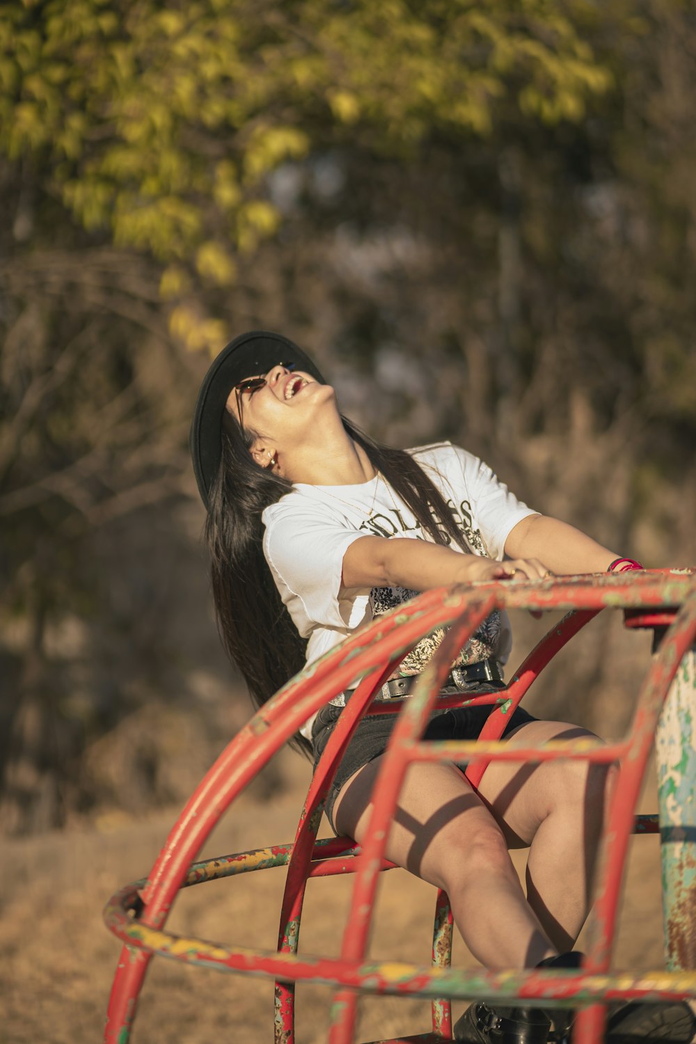 a woman sitting on top of a red bench