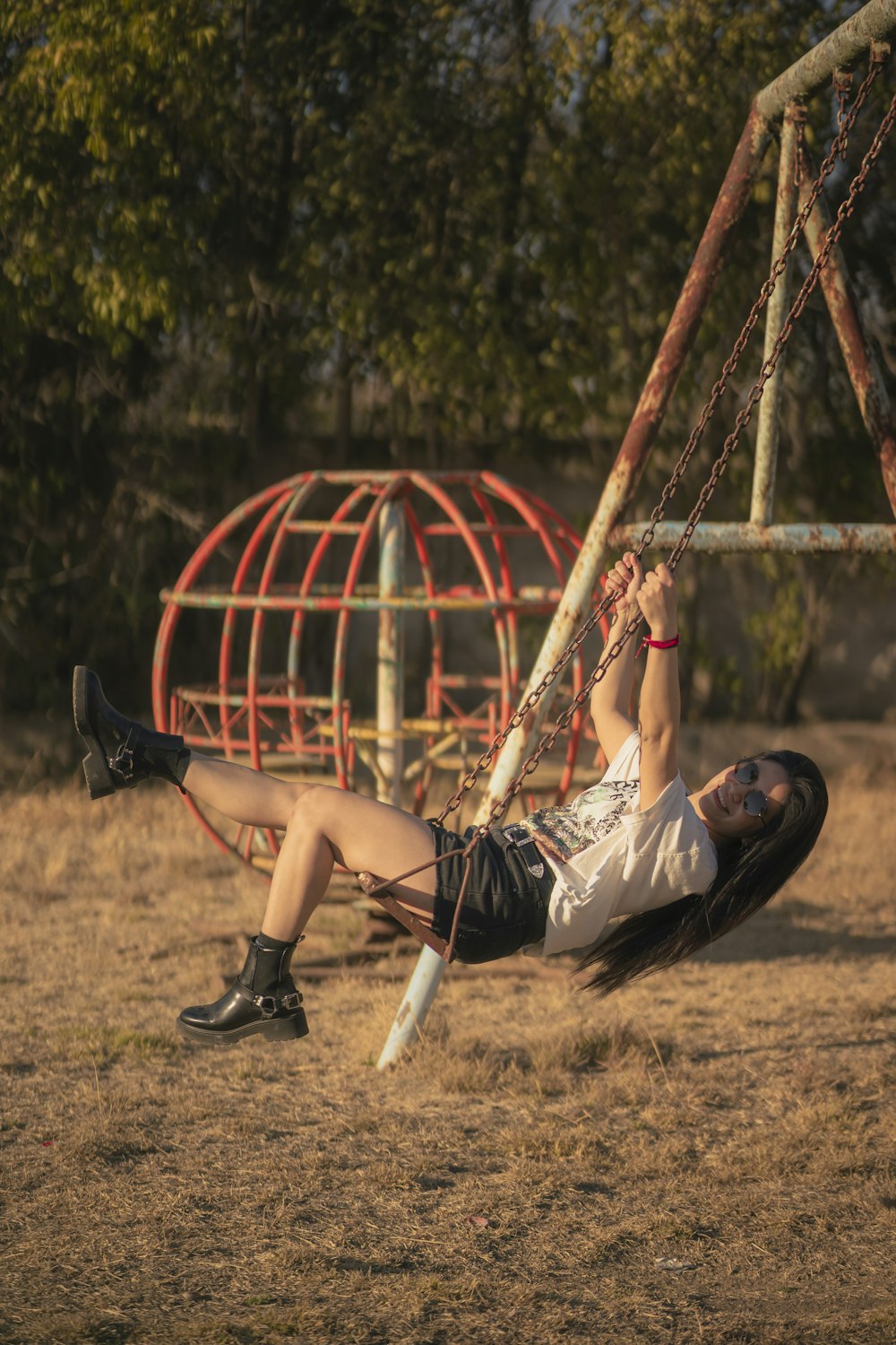 a girl is swinging on a swing set