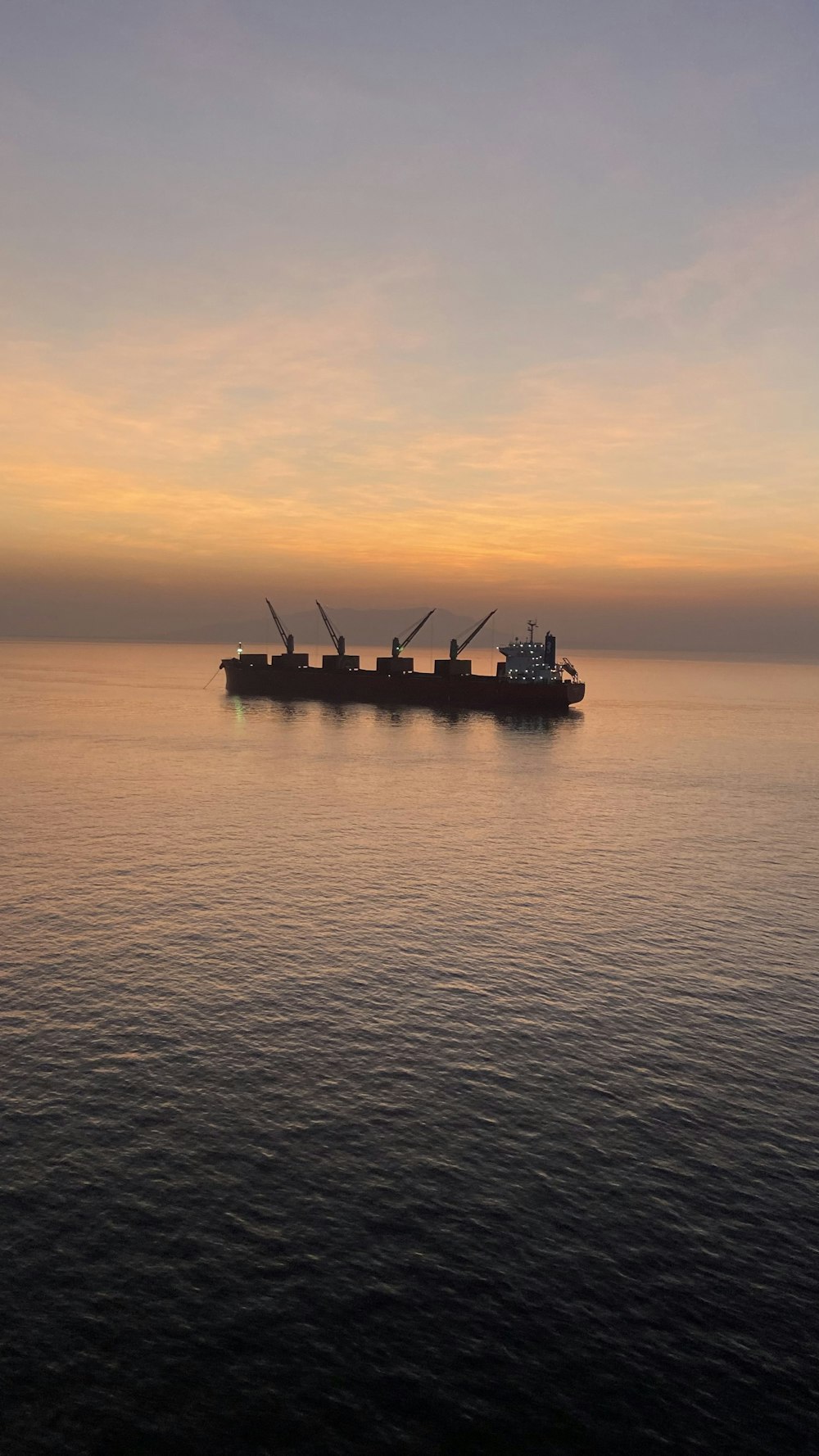 a large cargo ship in the middle of the ocean