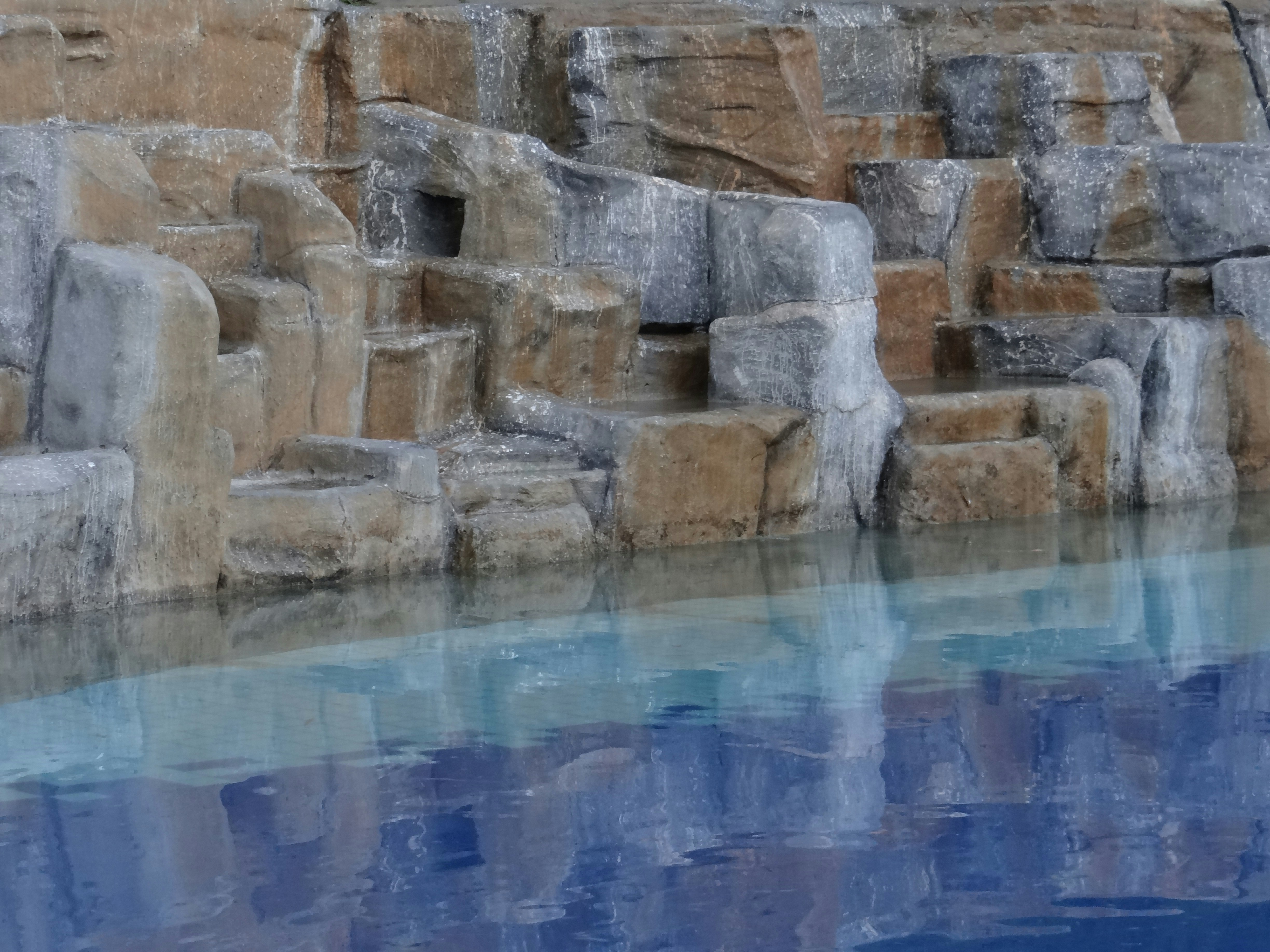a pool of water surrounded by large rocks