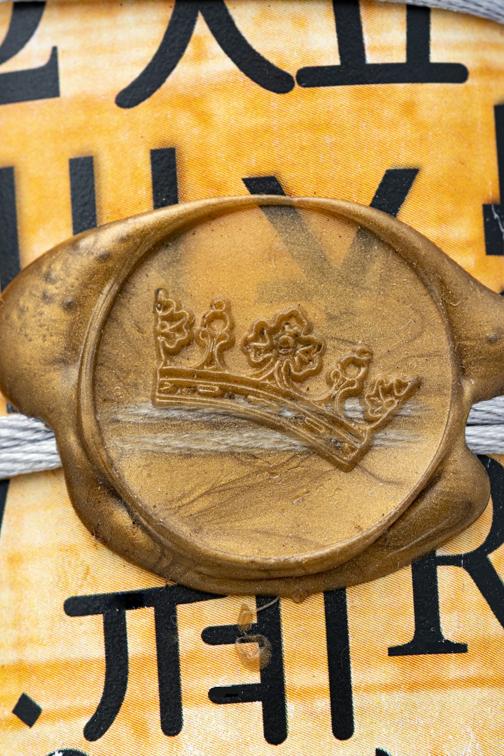 a close up of a metal object with a crown on it
