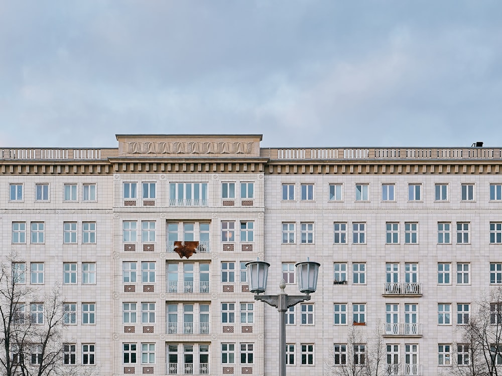 a tall white building with lots of windows