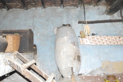 Interior of a rustic kitchen with wooden beams and traditional stove.