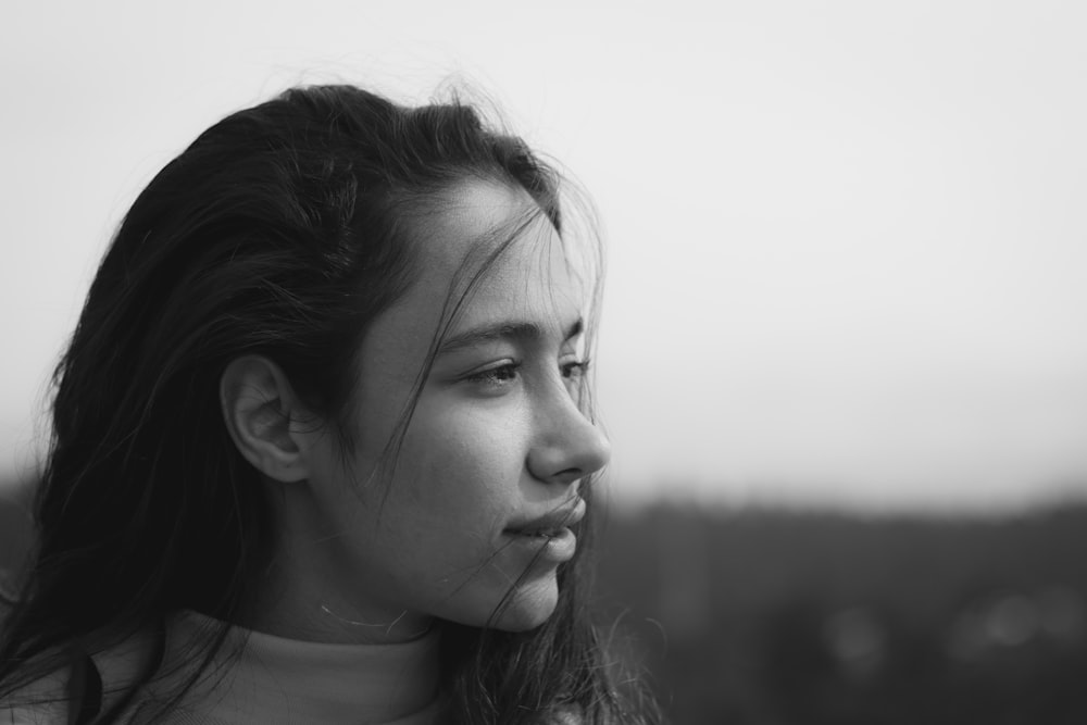 a black and white photo of a woman with long hair