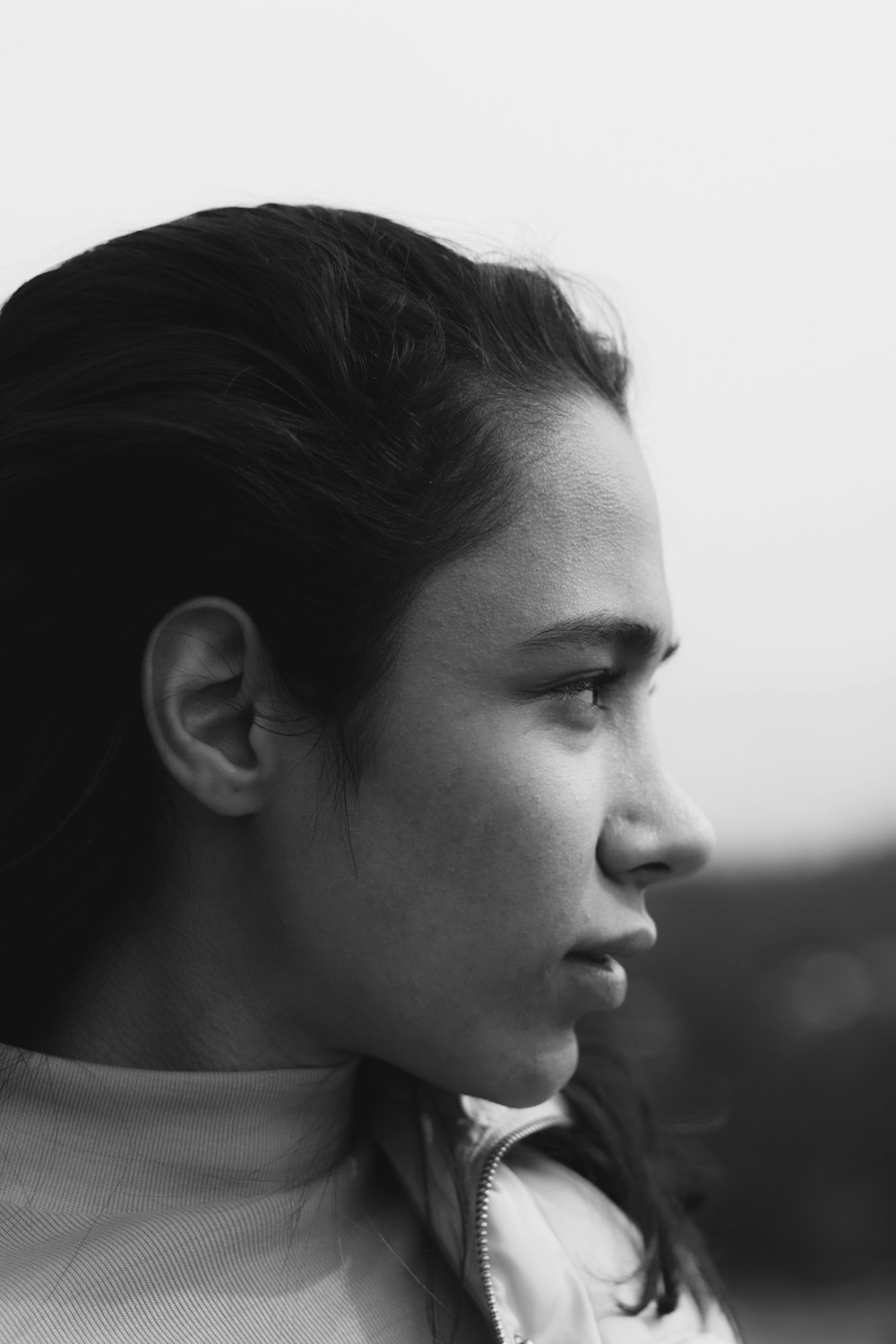 a black and white photo of a woman with a ponytail