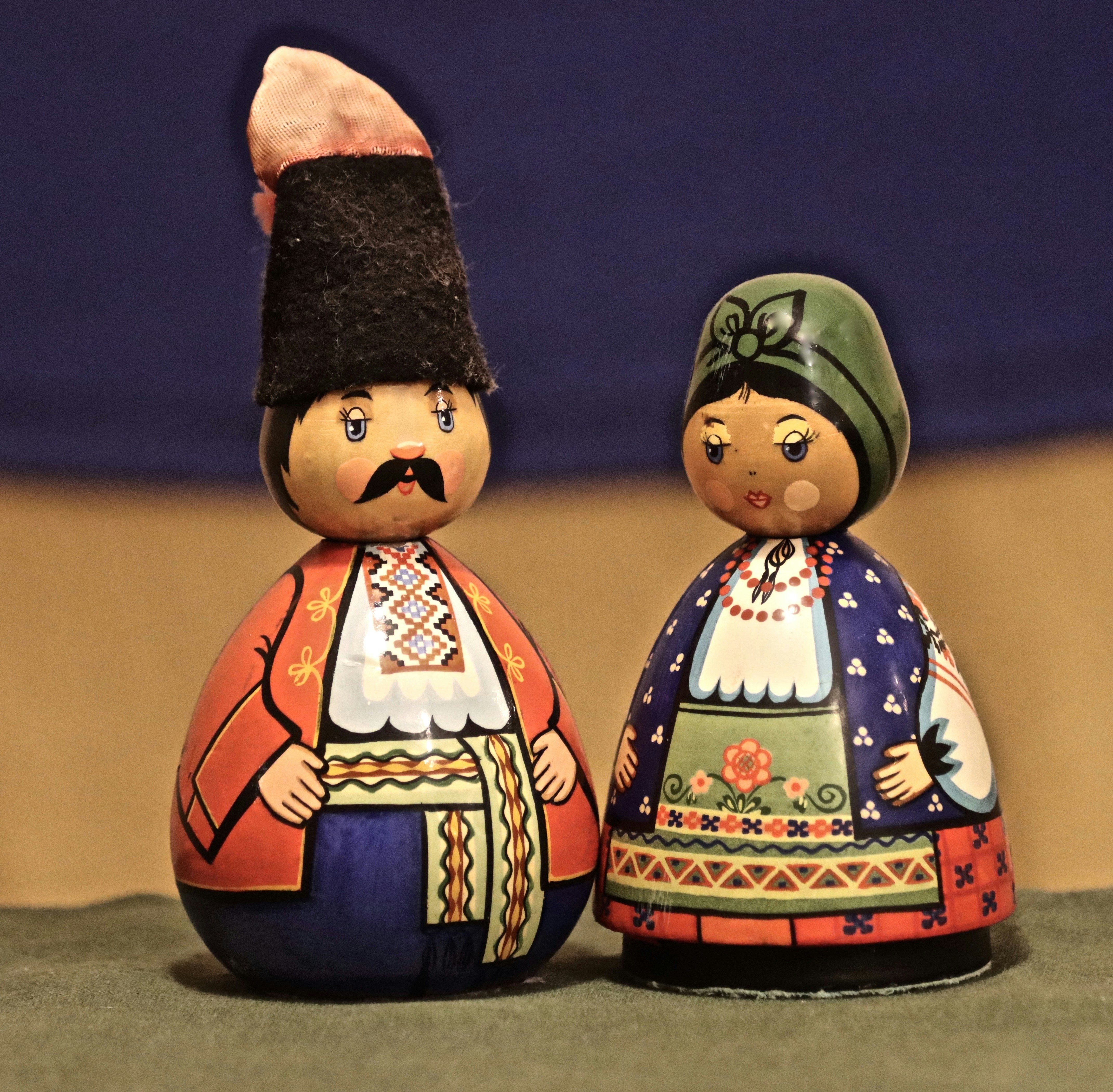 a couple of figurines sitting on top of a table