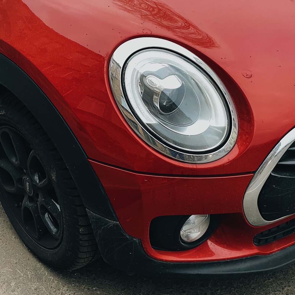 a close up of the front of a red car