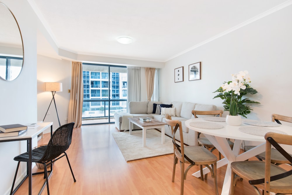 a living room filled with furniture and a dining room table