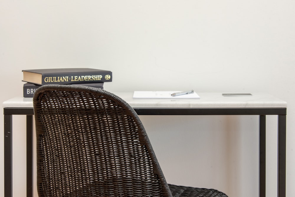 a chair sitting next to a table with a book on top of it