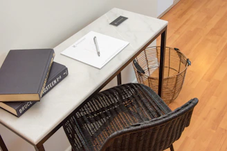 a table with two books and a pen on it