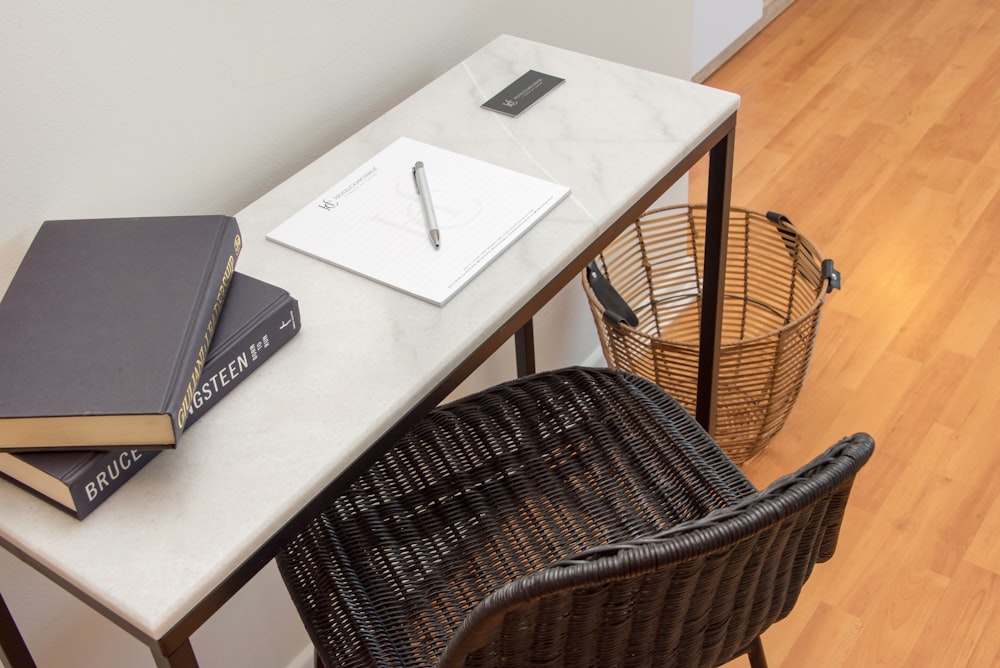 a table with two books and a pen on it