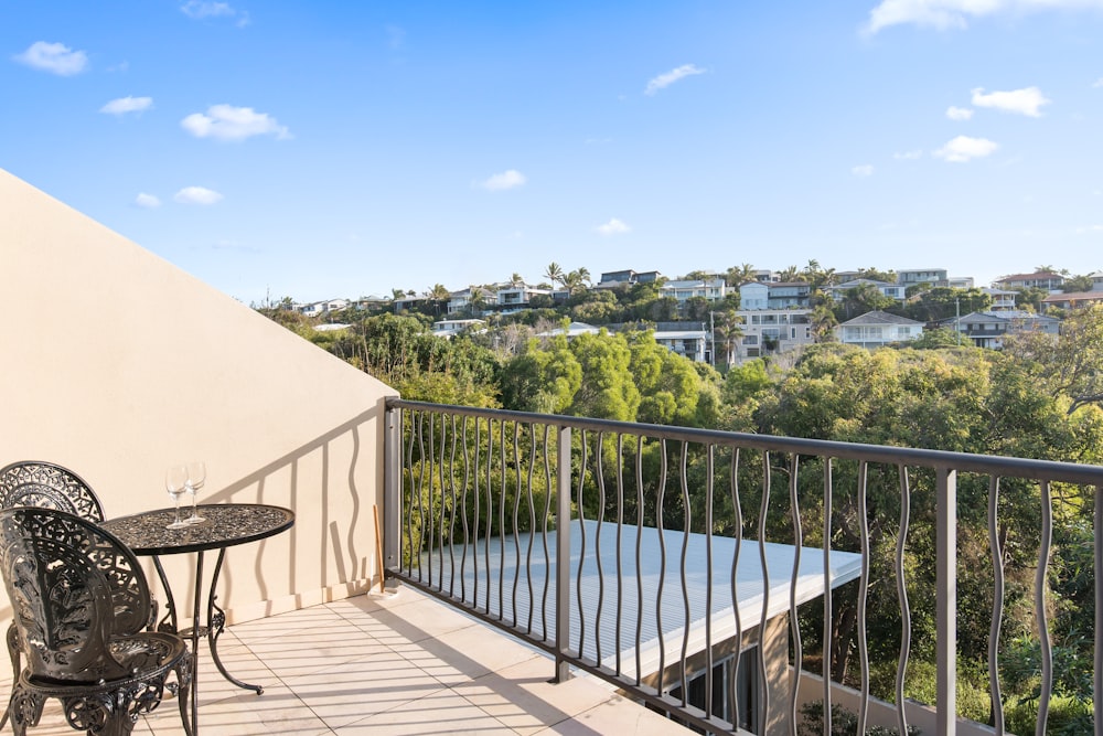 a balcony with a table and chairs on it