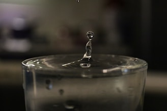 a drop of water falling into a glass of water