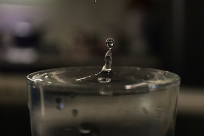 a drop of water falling into a glass of water