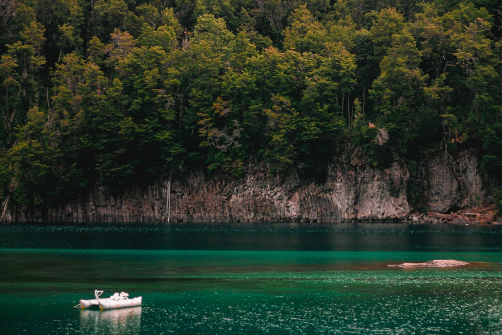 a small boat floating on top of a lake