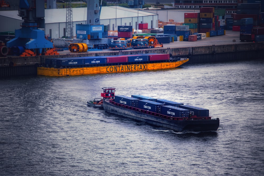 a large boat traveling down a river next to a dock