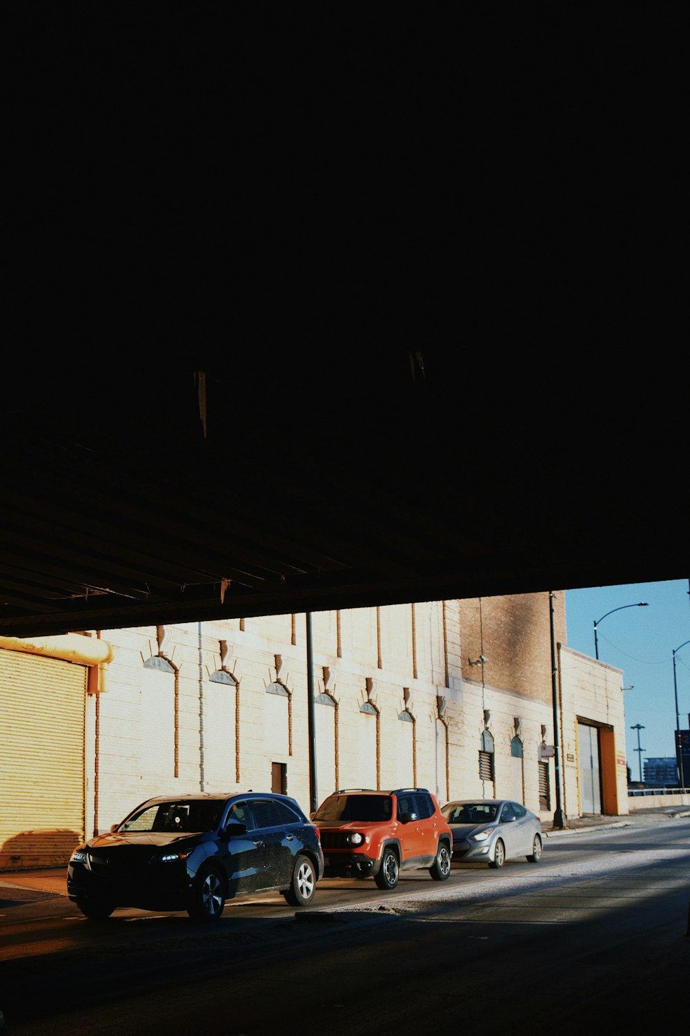 a couple of cars parked next to a building