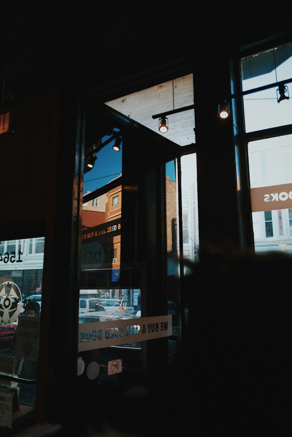 a store front window with a clock on it