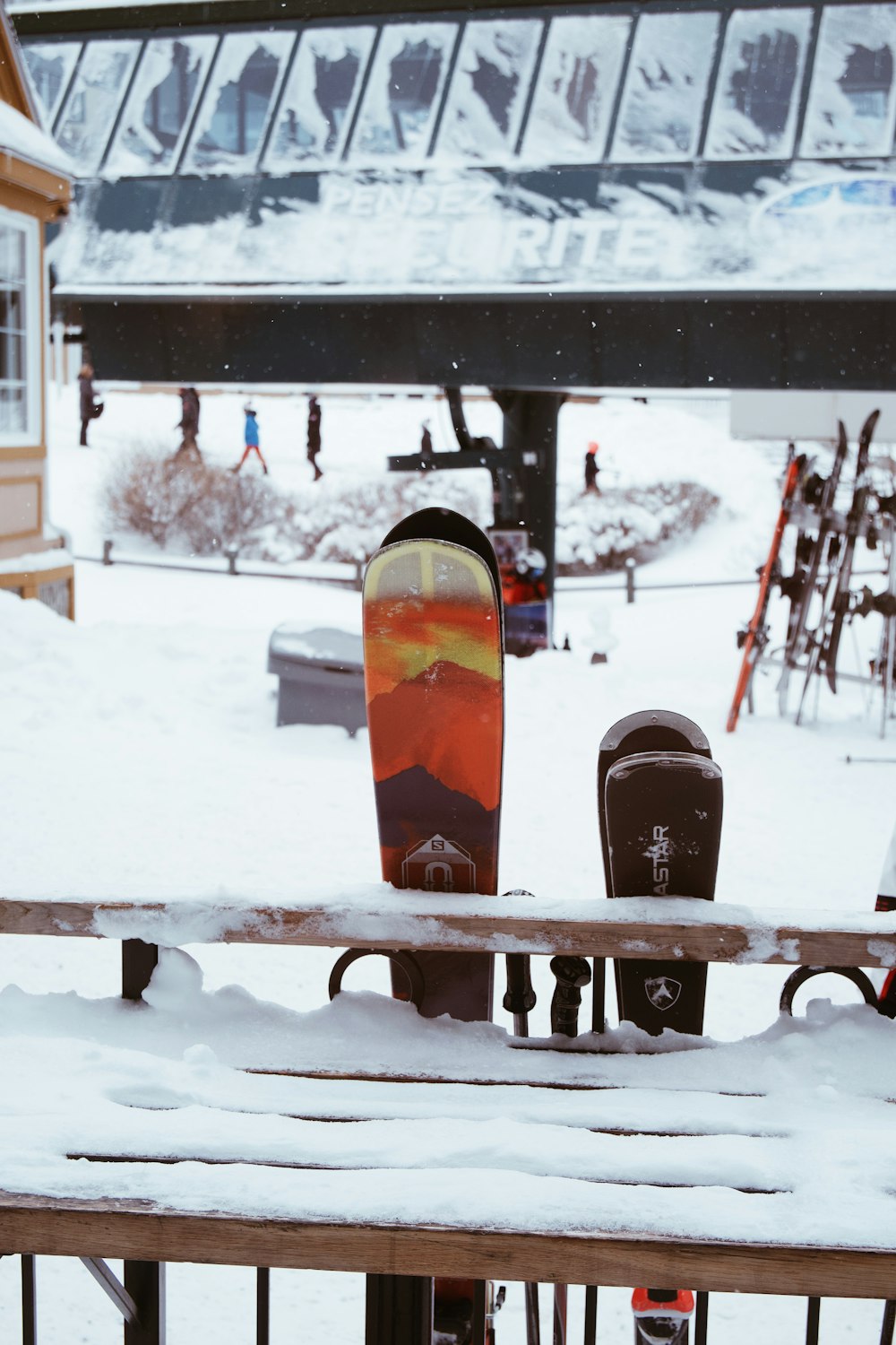a pair of snowboards sitting on top of a wooden bench