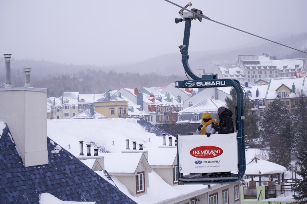 a ski lift with a person on it in the snow