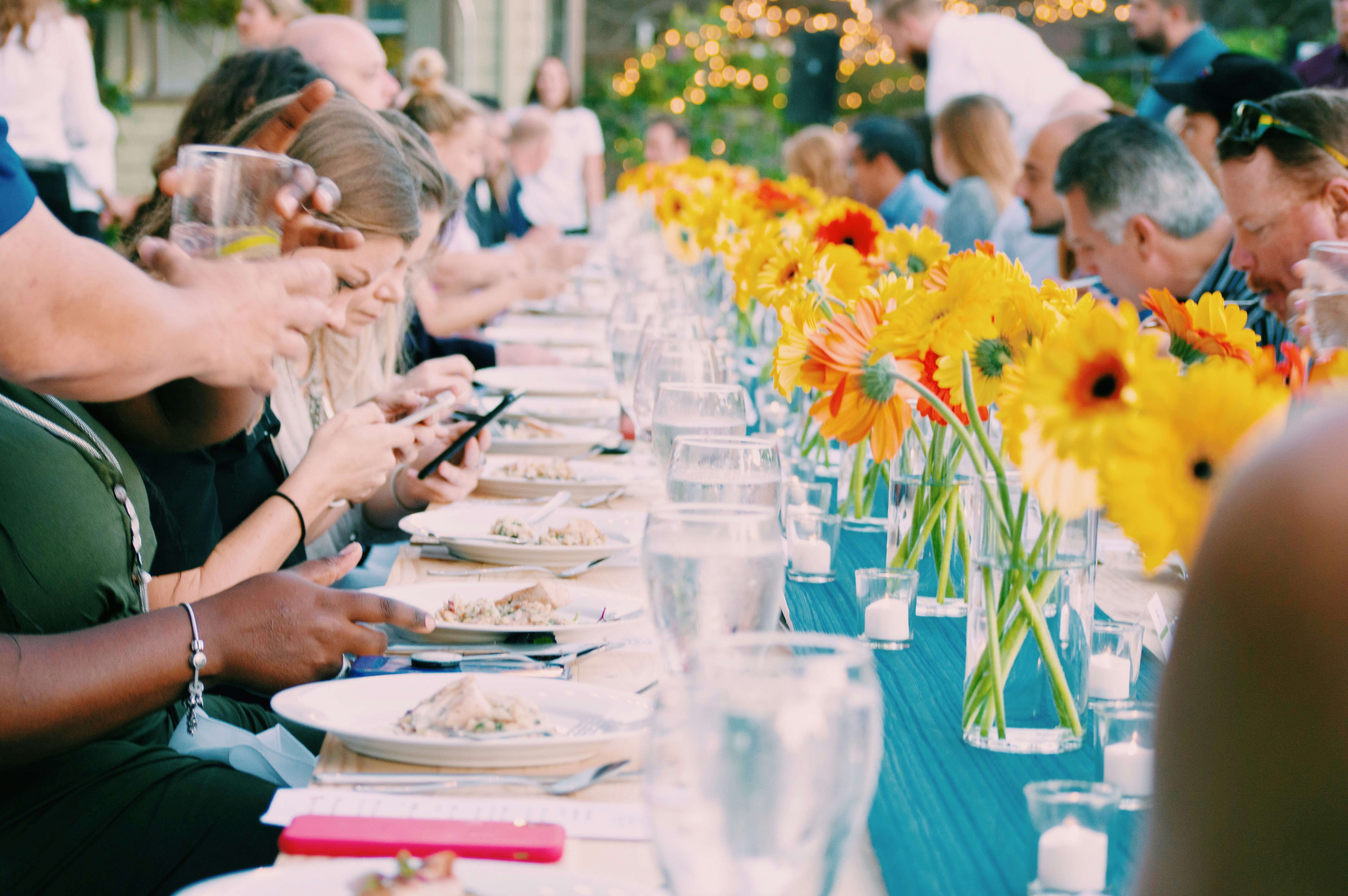 Illustration showing people using smartphones at a dinner table, ignoring each other