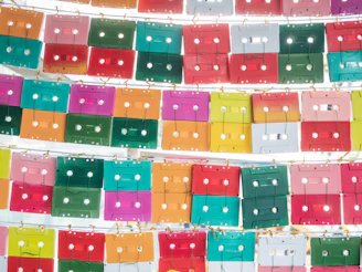 Close-up of colorful CD cases aligned perfectly in a grid layout.