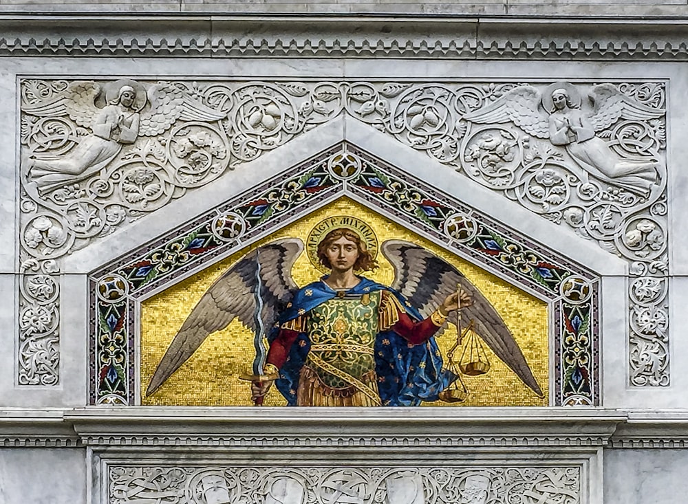 a mosaic of an angel on the side of a building