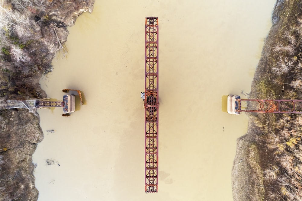 an aerial view of a bridge over a body of water