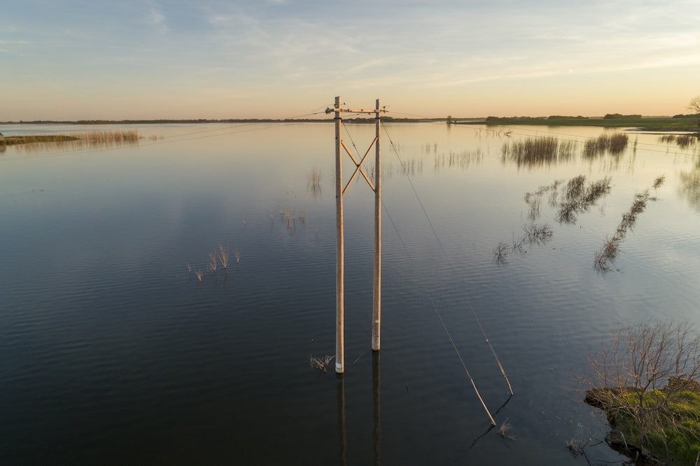a large body of water with a telephone pole in the middle of it