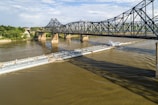 a large barge traveling down a river under a bridge