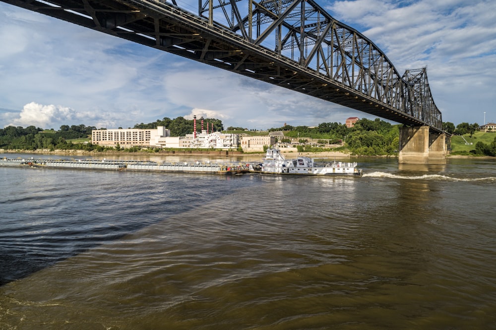 a boat is going under a bridge on a river