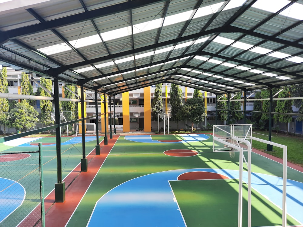 an indoor basketball court with a basketball hoop