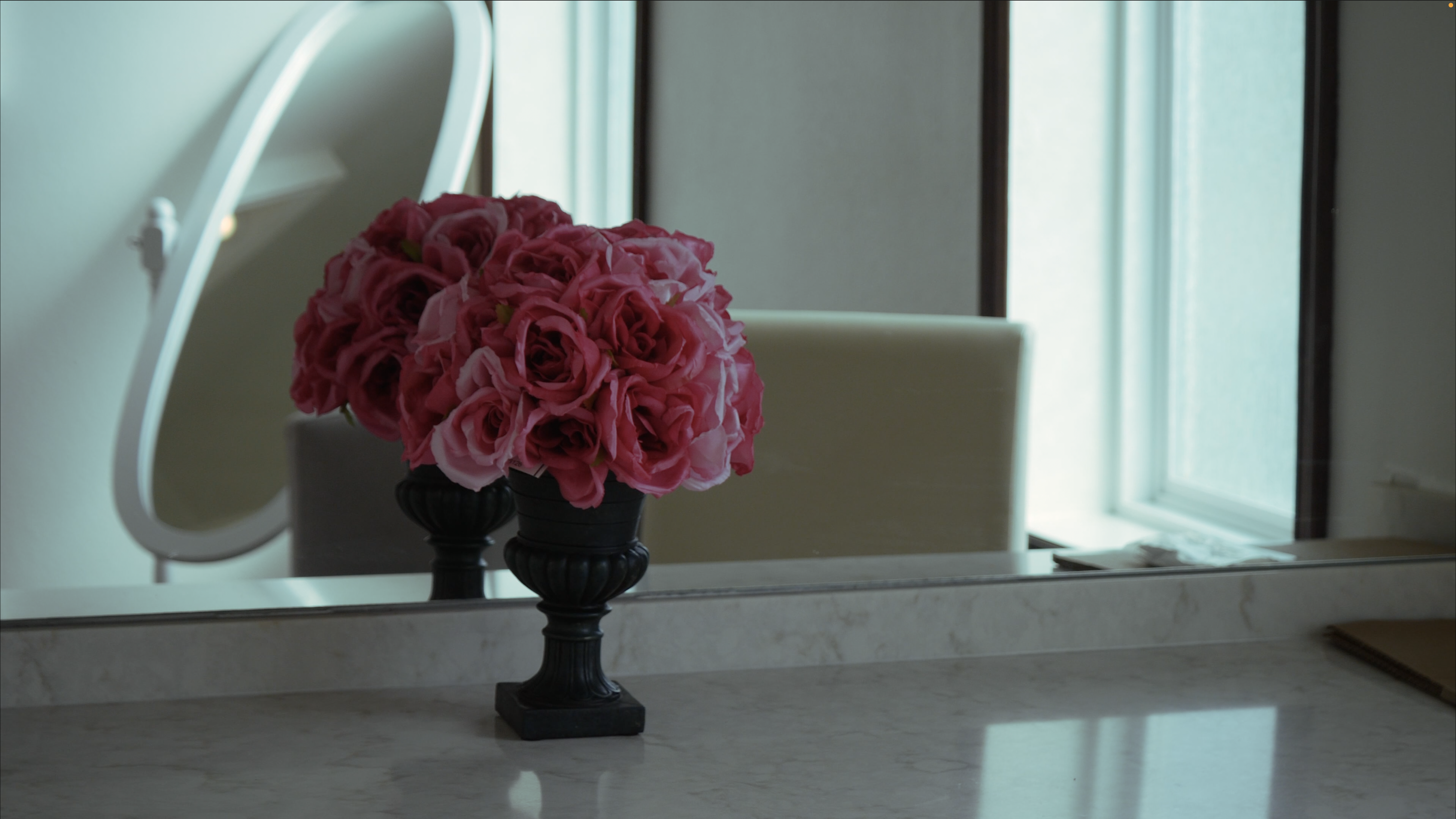Long lasting roses and forever flowers arrangement on marble countertop