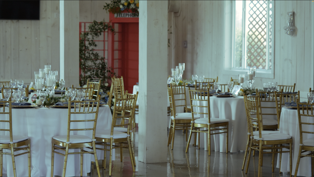 ein Raum gefüllt mit vielen Tischen, die mit weißen und goldenen Tüchern bedeckt sind