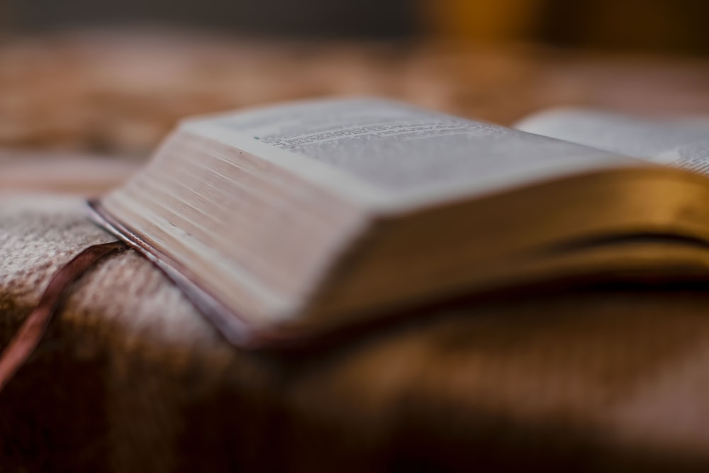 an open book sitting on top of a bed