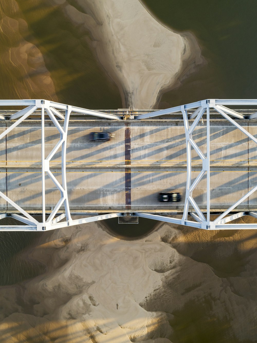 an aerial view of a bridge over a body of water