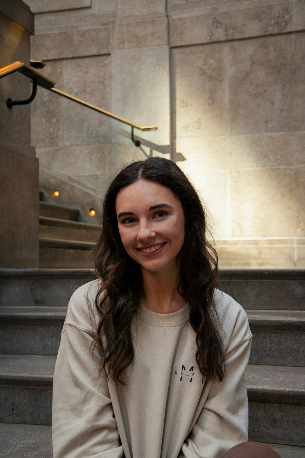 a woman sitting on the steps of a building