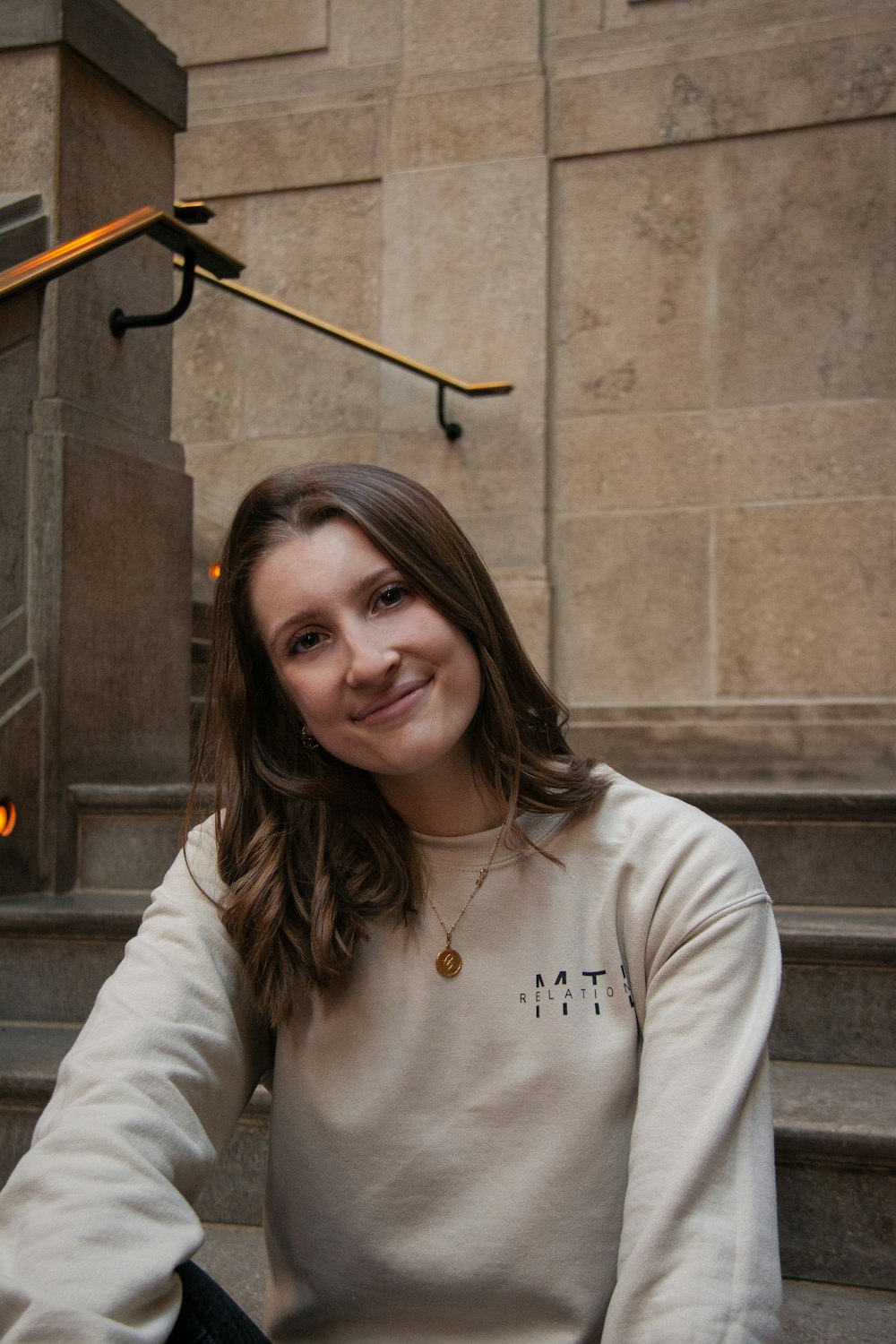 a woman sitting on the steps of a building