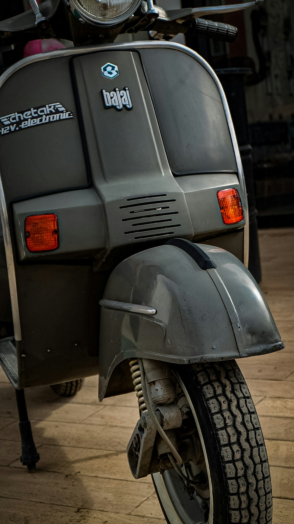 a scooter is parked on a wooden floor