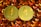 Two gold coins featuring the Ethereum logo are surrounded by numerous shiny, orange gemstones on a dark background. The coins have the Ethereum symbol and the word 'Ethereum' embossed on them.