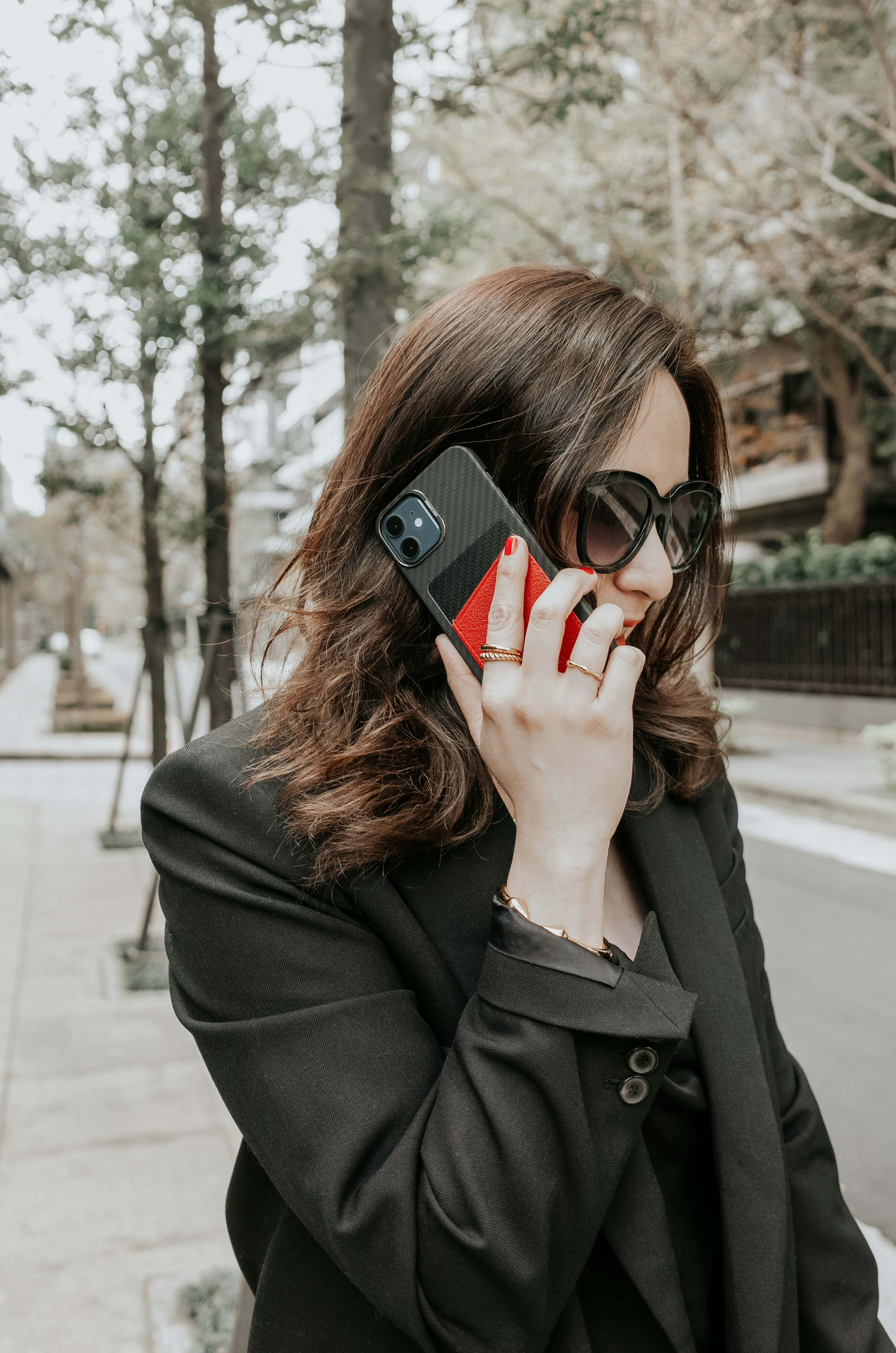 a woman talking on a cell phone while wearing sunglasses