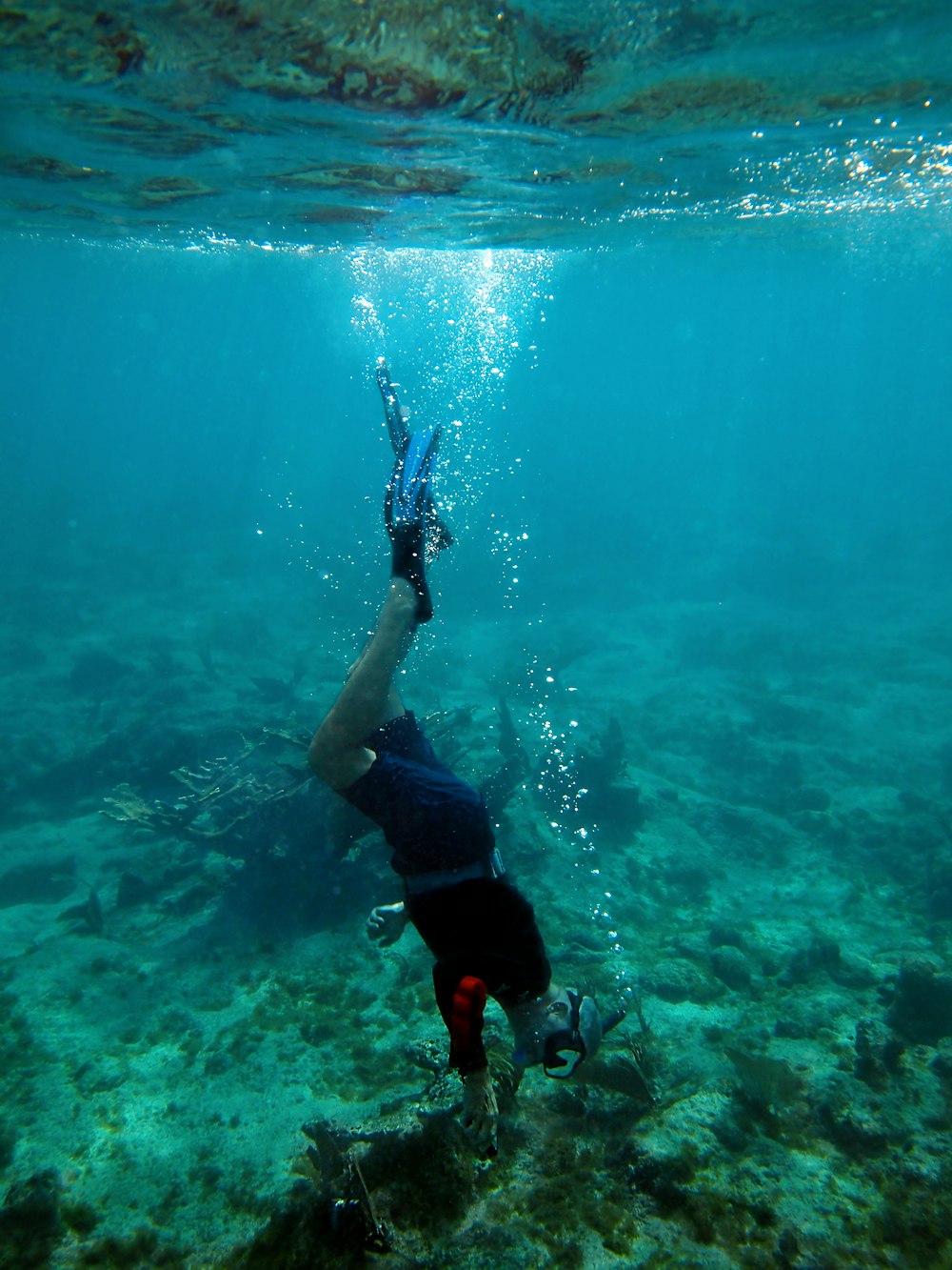 a man holding a pair of skis under water