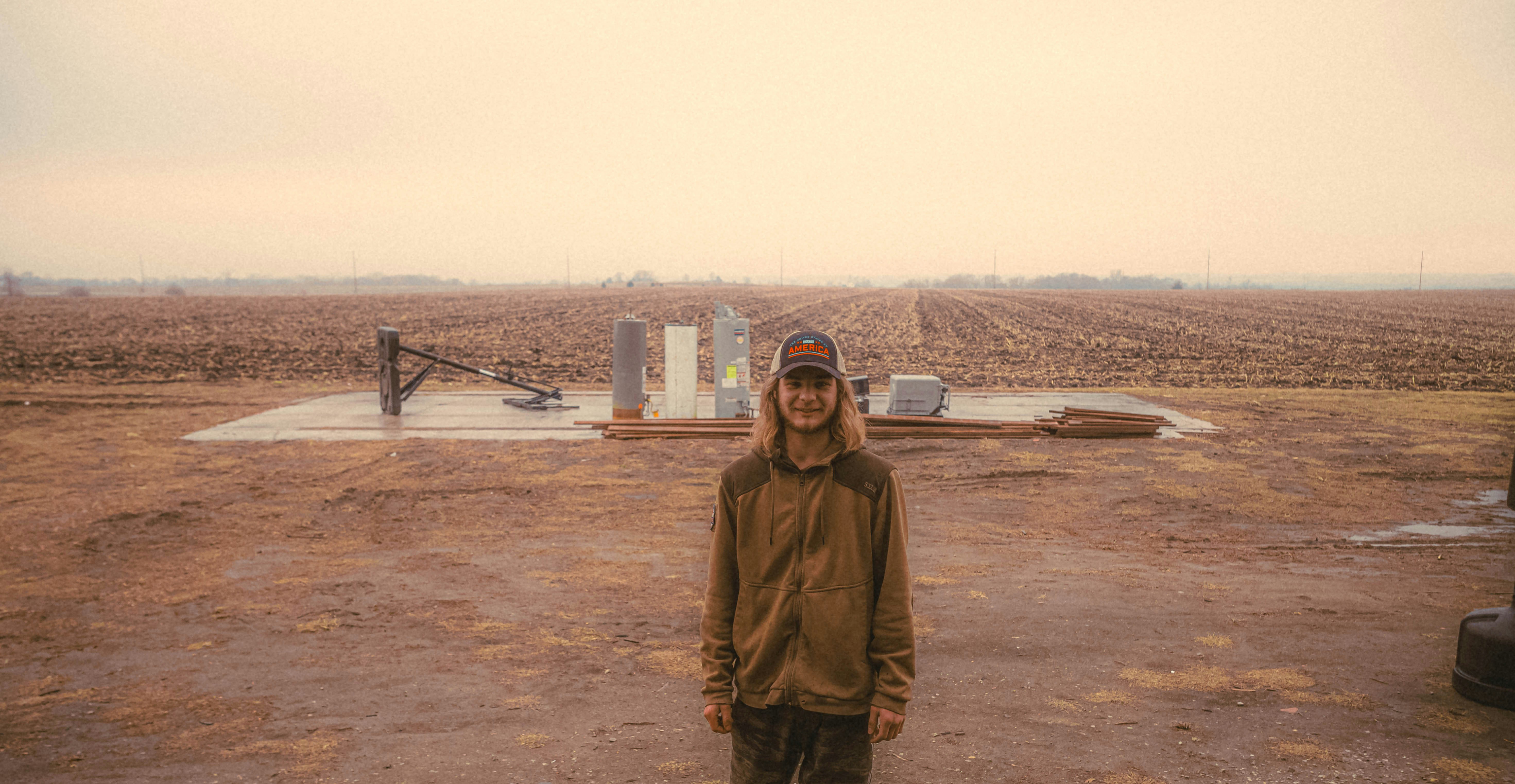 a person standing in a field with a plane in the background (Photo by Frankie Cordoba on Unsplash)