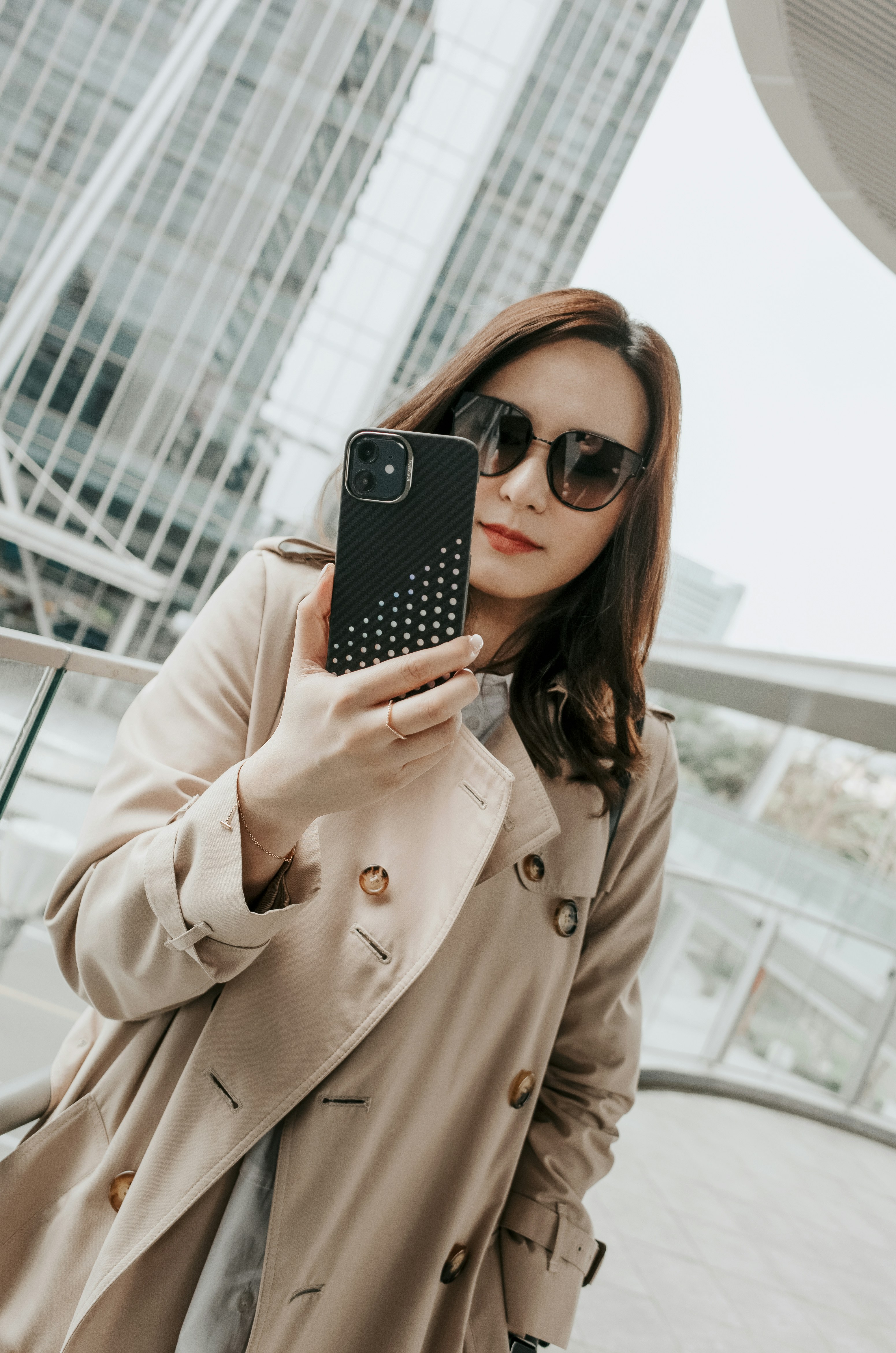 a woman taking a picture of herself with her cell phone
