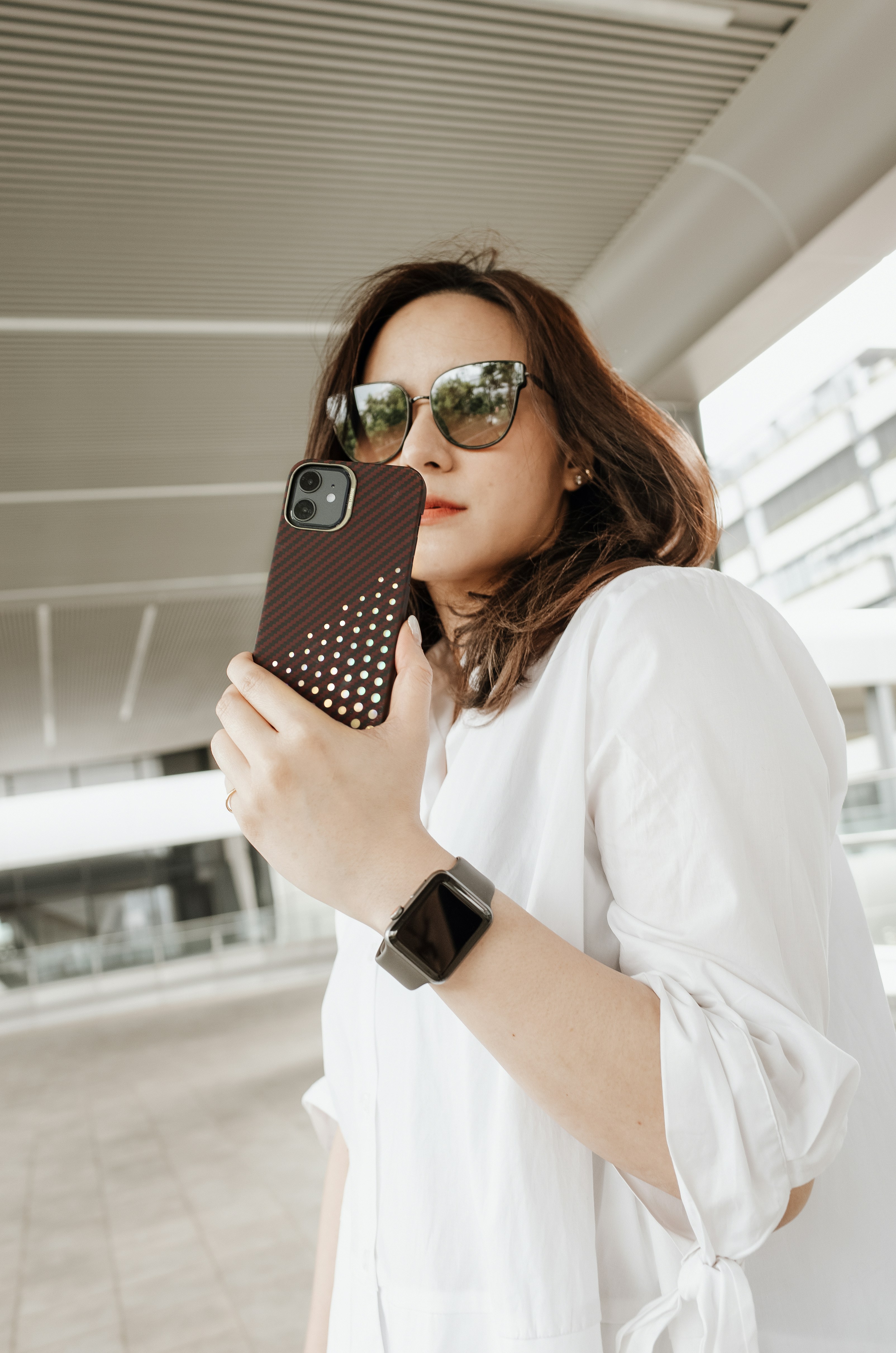 a woman taking a picture with her cell phone