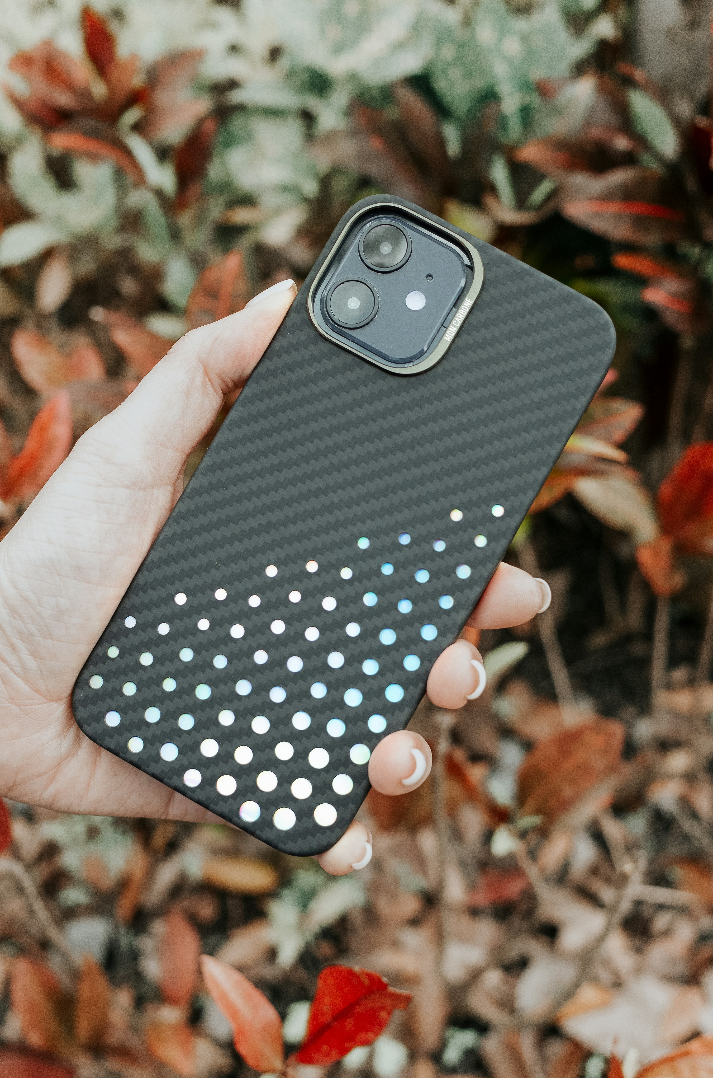 a person holding a cell phone in their hand