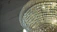 A close-up of a crystal chandelier casting sparkling light over a cozy dining table.